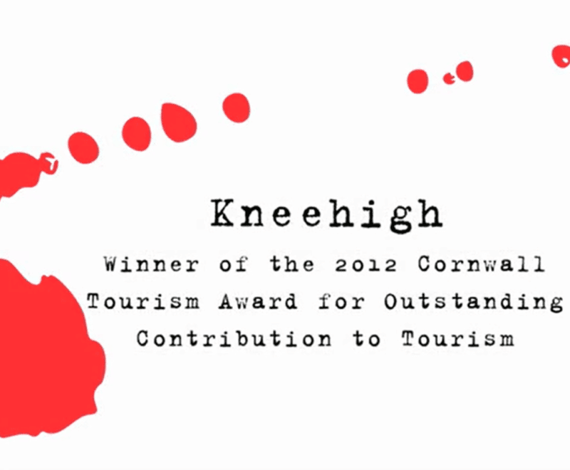 'Kneehigh Award' in lowercase black typewriter style font is centered in the image. A red mark, as if a splash of ink, surrounds the text, diminishing from bottom left corner to top right.