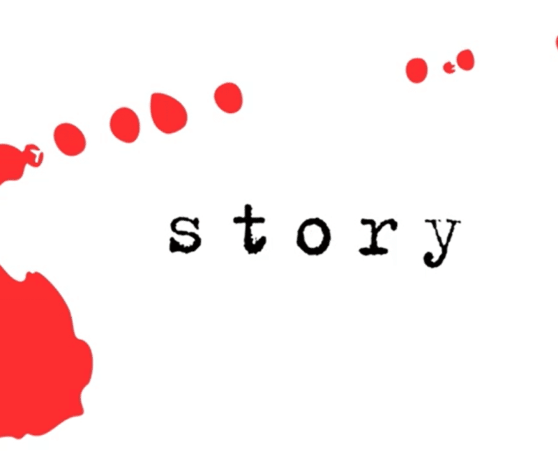 The word 'story' in lowercase black typewriter style font is centered in the image. A red mark, as if a splash of ink, surrounds the text, diminishing from bottom left corner to top right.