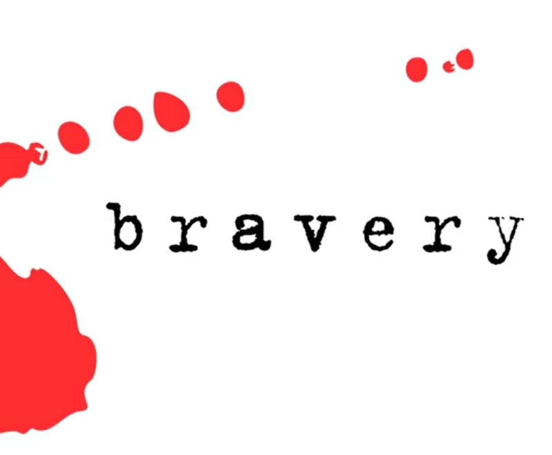 The word 'bravery' in lowercase black typewriter style font is centered in the image. A red mark, as if a splash of ink,