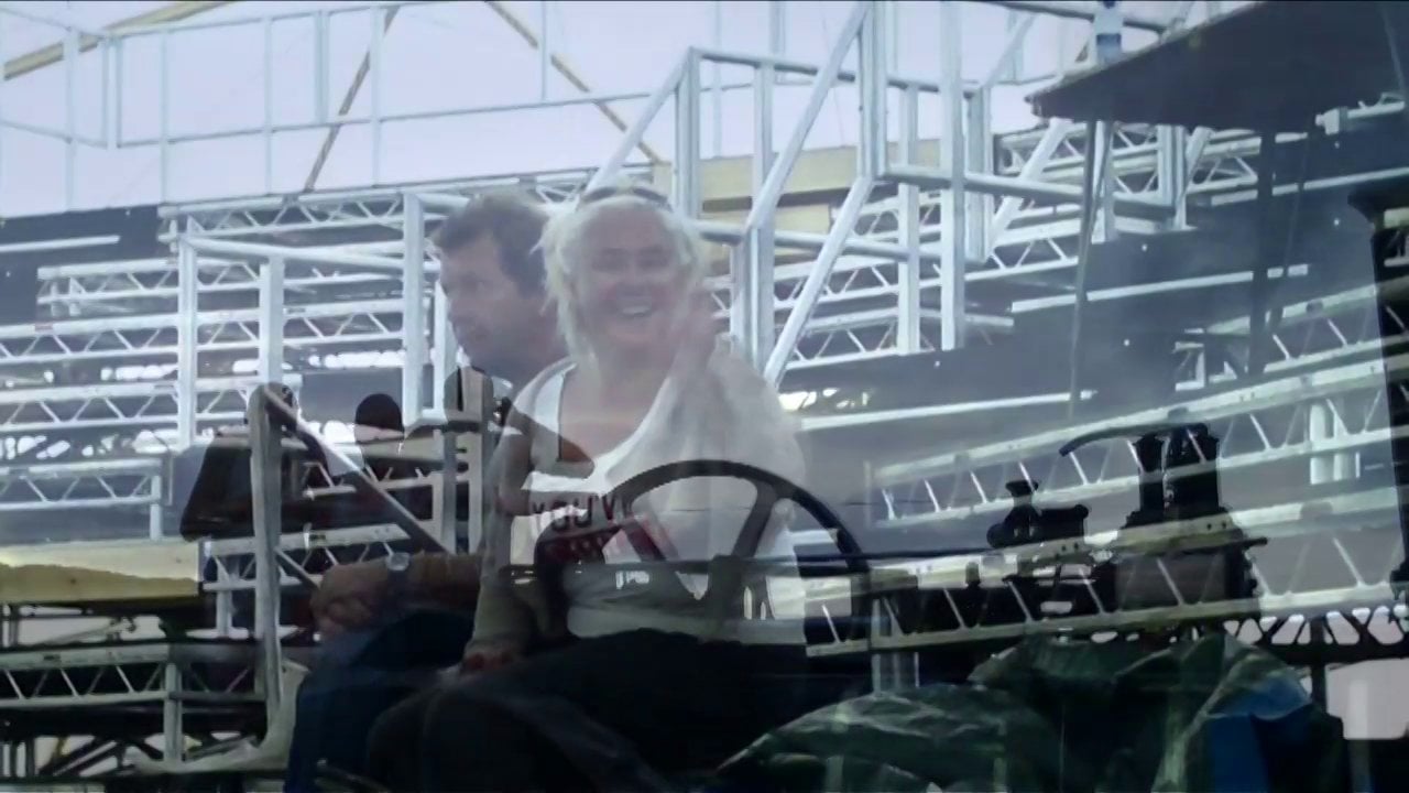 A man and a woman enjoying a roller coaster ride.