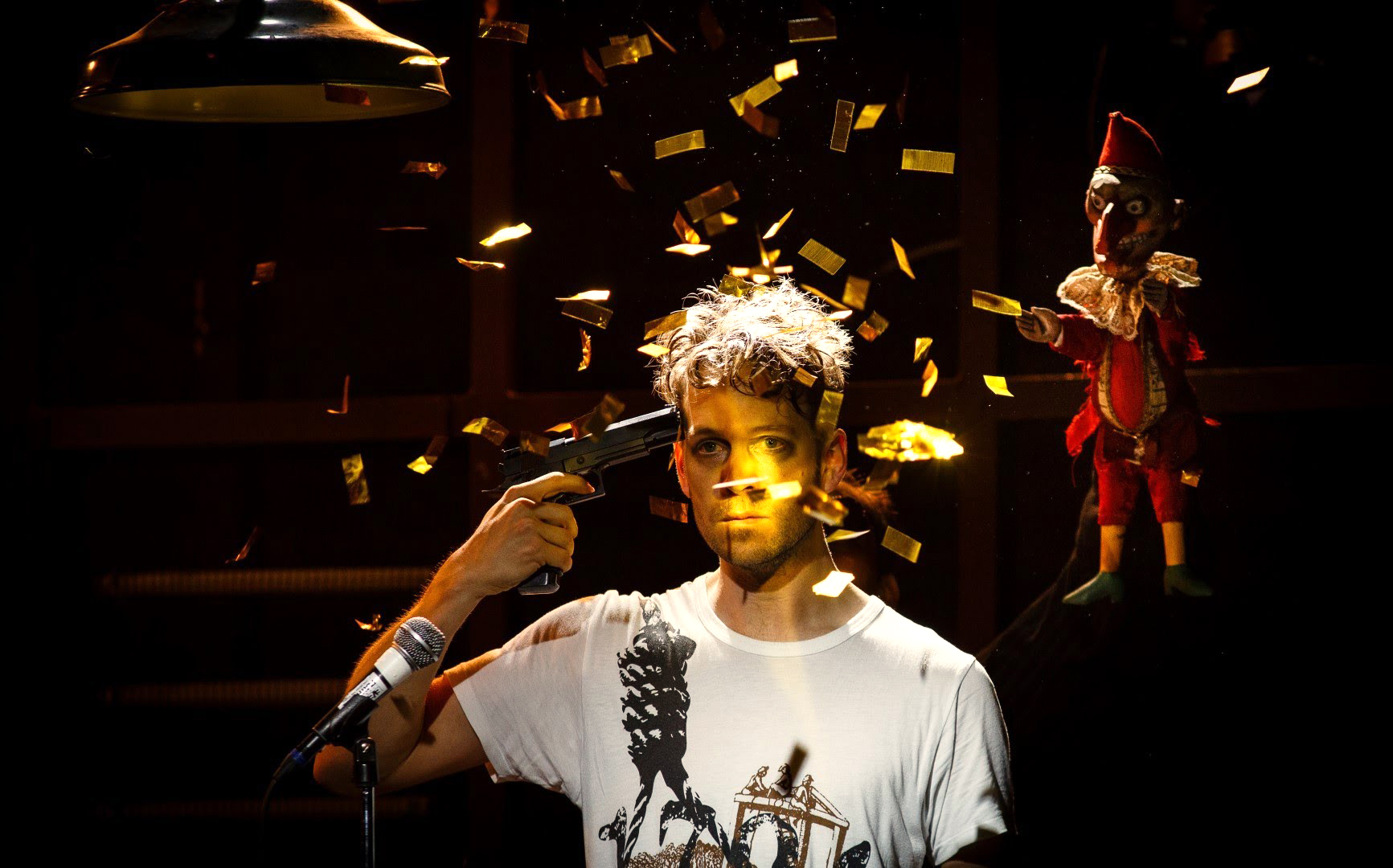 A man holding a gun in front of confetti.