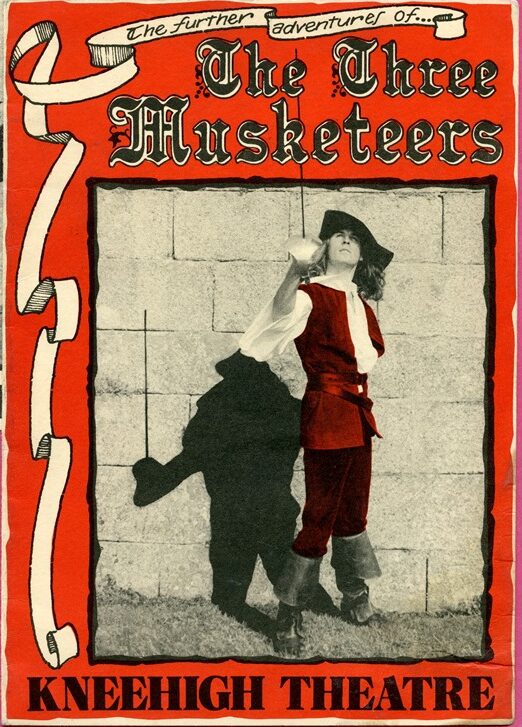 Poster for 'The Three Musketeers', featuring a black, red and white design. Text is featured in an elaborate historic font, alongside an image of a man in eighteenth century dress bearing a sword.