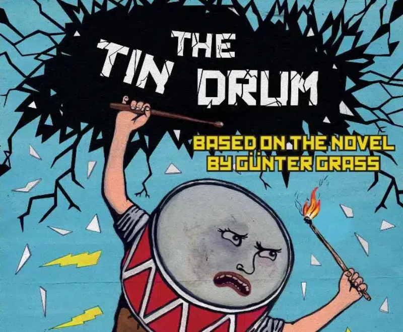 Flyer for Kneehigh's The Tin Drum. Depicted is an image of a a drum that has arms and legs. The drum has an angry facial expression and is carrying drumsticks , one is on fire. The drum is large and towering over a town and one foot is crushing a building that is on fire. Buildings, green fields and blue sky can be seen in the background. Above the drum is yellow text which states ' Based on the novel by Gunter Grass'. There is a black cloud above the drum which has 'The Tin Drum' in white text. The borders of the flyer are black with red text that repeats all the way round. The text reads ' IT MUST BE DONE ,I AM LIGHT!, I AM LIFE!, I GOT A BRAIN LIKE A BOMB AND TONGUE LIKE A KNIFE!