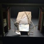 A blurry photo of a prop for the Flying Lovers of Vitebsk set on a small black stage with ornate green and gold pillars on either side.