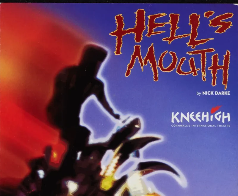 Image features a digitally created image of a silhouette riding a motor cycle across the page. The production title 'Hell's Mouth' is presented in the top right of the image in a fuzzy red front set against a clear blue sky. Small white text below the title reads 'by Nick Darke'.