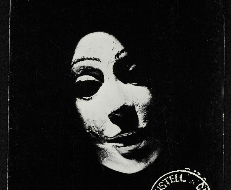 A black portrait programme cover for Tregeagle. Features a white poorly illuminated mask. Text reading 'Kneehigh Theatre' is presented in a bold white text.