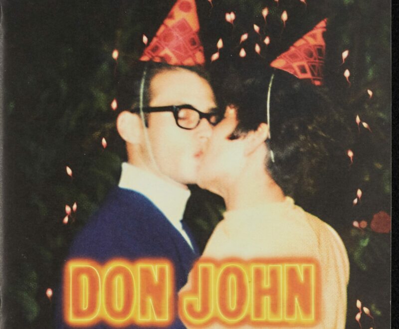 The image features a blurry image of two individuals wearing party hats kissing. Below the pair is text reading 'Don John' in bold neon orange font. The logo of the Royal Shakespeare Company is in the top left corner.