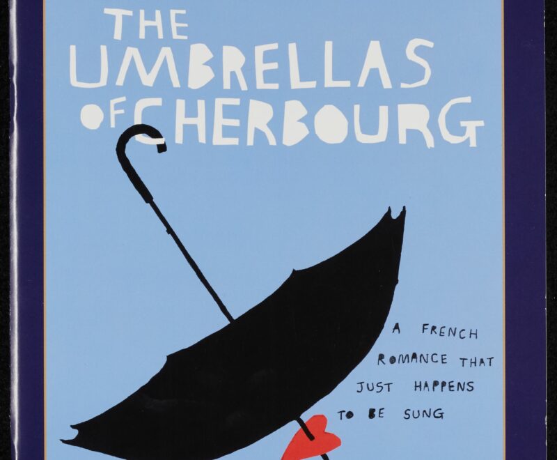 Image features a cartoon illustration of an upside down black umbrella set against a light blue background. The top of the umbrella is piking through a red cartoon heart and is placed next to text reading 'A French Romance that just happens to be sung'. There is a darker blue border all around the image which features 'Gielgud Theatre' written in a thin white text.