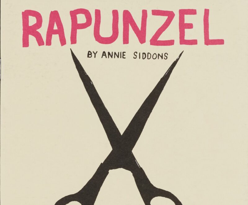 A black silhouette of black scissors set against a grey backdrop. Text reading 'RAPUNZEL' is presented in bold pink text above the illustration. Smaller black text reads 'By Annie Siddons'.